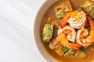 Sour soup made of Tamarind Paste with Shrimps and Vegetable Omelet photo