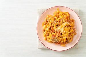 homemade macaroni bolognese with cheese photo