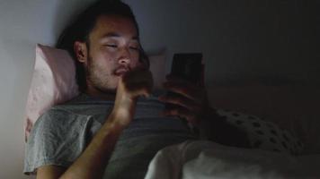 Asian men using a smartphone browsing web and scroll through social media feeds on mobile phones. video