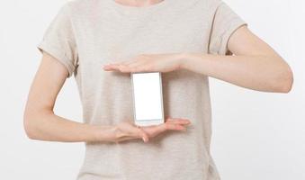 woman shows blank display of mobile phone, hand points to device, blank screen cellular photo