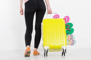 girl with suitcase isolated on white background .Summer holidays. summer flip flops or slippers. Travel valise or bag. Mock up. Copy space. Template. Blank. photo