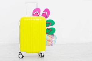 suitcase isolated on white background Summer holidays. summer flip flops or slippers.Sandals beach.Red cap.Travel valise or bag. Mock up. Copy space. Template. Blank. photo