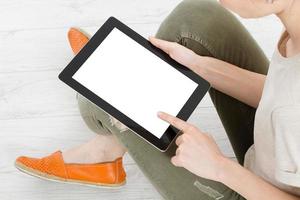 Girl sitting with tablet in hands.Top view.Mock up.Copy space.Template.Blank. photo