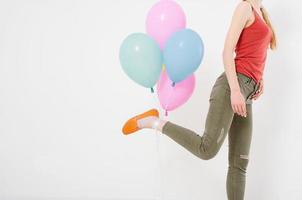 young woman girl running with colored balloons isolated on white background. Copy space photo