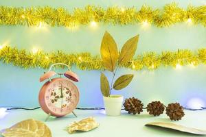 Minimalist concept idea displaying products. christmas and new year backgrounds. alarm clock. pine flower photo