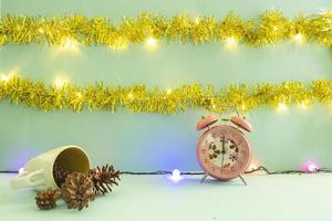 Minimalist concept idea displaying products. christmas and new year backgrounds. alarm clock. pine flower photo