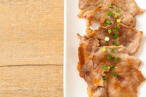 grilled pork neck sliced on plate photo