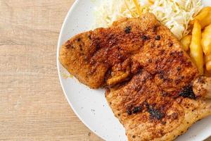 grilled spicy barbecue pork steak with french fries photo