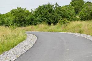 Beautiful empty asphalt road in countryside on colored background photo