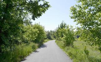 Beautiful empty asphalt road in countryside on colored background photo