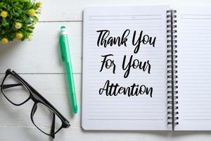 Notebook written with Thank You For Your Attention on wooden background photo