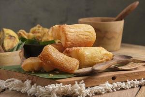 Fried Cassava served on wooden table photo