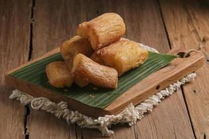 Fried Cassava served on wooden table photo