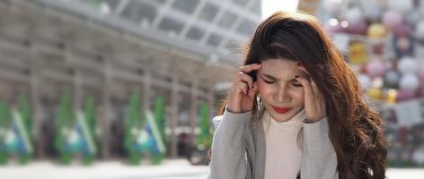 Lay off. Sacked. Fired business woman sitting on stairs of office building outside. photo