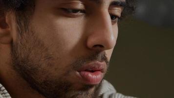 Extreme close up of face of young Middle Eastern man, looking focused photo