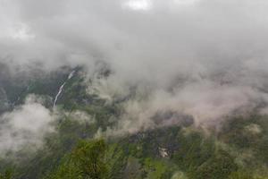 Fog mist clouds waterfalls on mountain norwegian landscape Utladalen Norway.