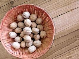 Walnuts in shell on wooden background