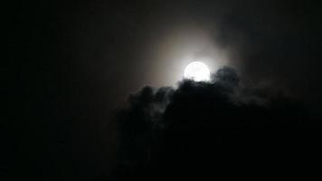 Clouds moving across a full moon video