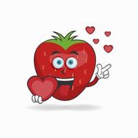 Strawberry mascot character holding a love icon. vector illustration