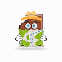 The Chocolate mascot character holds a map. vector illustration