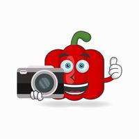 Red paprika mascot character holding camera. vector illustration