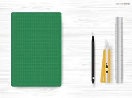 Green cutting mat with stationary object on white wood background. Vector. vector