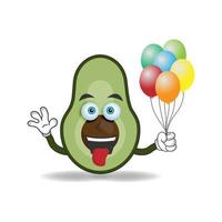 Avocado mascot character holding a balloon. vector illustration