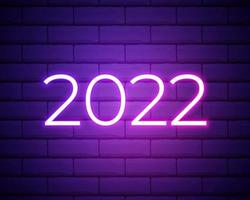 2022 neon signboard. Happy New Year. Realistic pink neon numbers on dark brick wall. Vector 2022 in neon linear style.