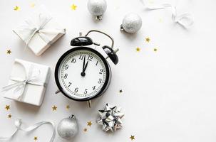 Christmas composition with alarm clock and decorations photo