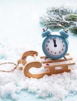 Christmas alarm clock on a toys sled photo