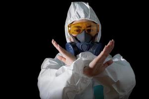 Woman in chemical protective clothing and antigas mask with glasses at white background, Women scientist in safety suit, Safety virus infection concept photo