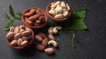 Pistachios or Pista nuts decorated with green leaves. plain background, top view.Flat lay. photo