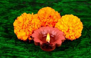 Happy Diwali - Diya lamps lit during Diwali celebration. Colourful and decorated lantern are lit in night on this occasion with flower Rangoli, sweets and gifts. photo