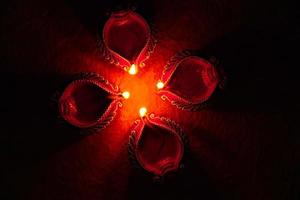 Happy Diwali - Diya lamps lit during Diwali celebration. Colourful and decorated lantern are lit in night on this occassion with flower rangoli, sweets and gifts. photo