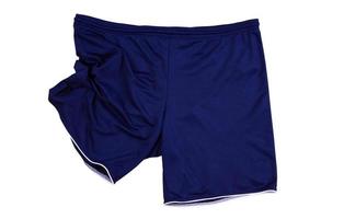 Folded dark blue sport shorts isolated on white, running shorts close up . photo