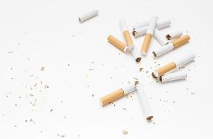 Vista aérea de tabaco de cigarrillos rotos contra el telón de fondo blanco foto