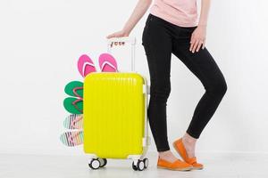 girl with suitcase isolated on white background .Summer holidays. summer flip flops or slippers. Travel valise or bag. Mock up. Copy space. Template. Blank. photo