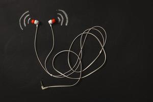 sound wave icon near earphone blackboard