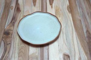 Empty plate on wooden table photo