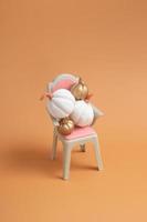 Autumn creative still life of white and gold pumpkins on the chair photo