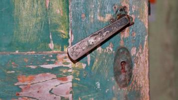 very worn and dirty doorknobs, very old and rusty photo