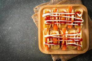 flat pancake roll with sausage and crab stick photo