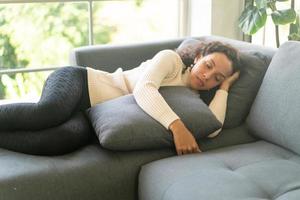 Latin woman sleeping on sofa photo