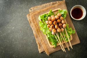 grilled meatballs skewer with spicy sauce photo