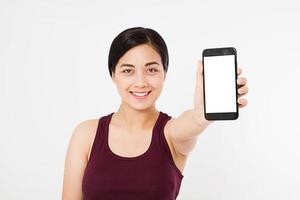 portrait of smile asian,korean woman,girl hold blank screen cellphone, isolated on white background, hand holding black phone,selective focus, copy space photo