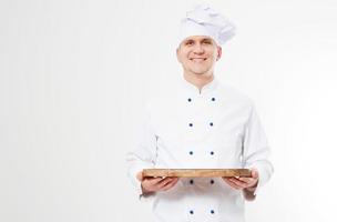 Sonrisa chef sosteniendo bandeja vacía aislado sobre fondo blanco, concepto de comida y bebida foto