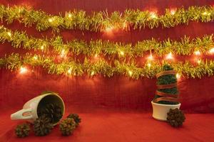 Minimalist concept idea displaying products. christmas and new year background.red, lights, pine flower photo