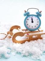 Christmas alarm clock on a toys sled photo