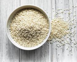 Sesame seeds in a bowl  on a rustic table photo