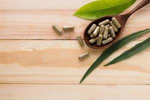Medicamento a base de hierbas o píldora sobre fondo de madera